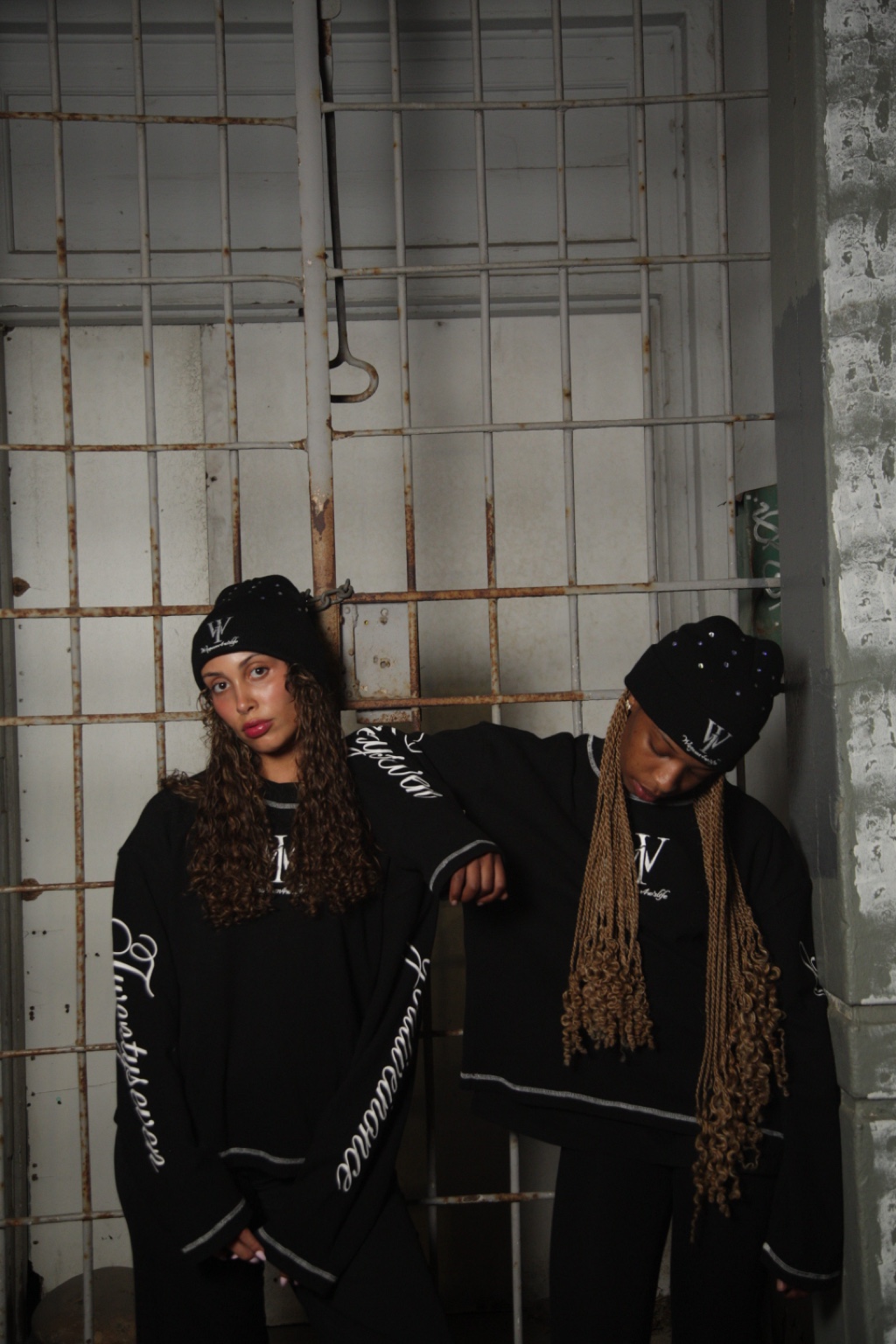 Two people wearing black WANOFWAN beanies together outside