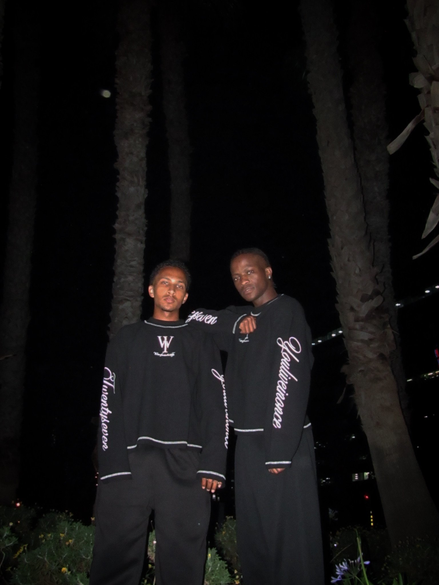 Two models wearing black WANOFWAN tops